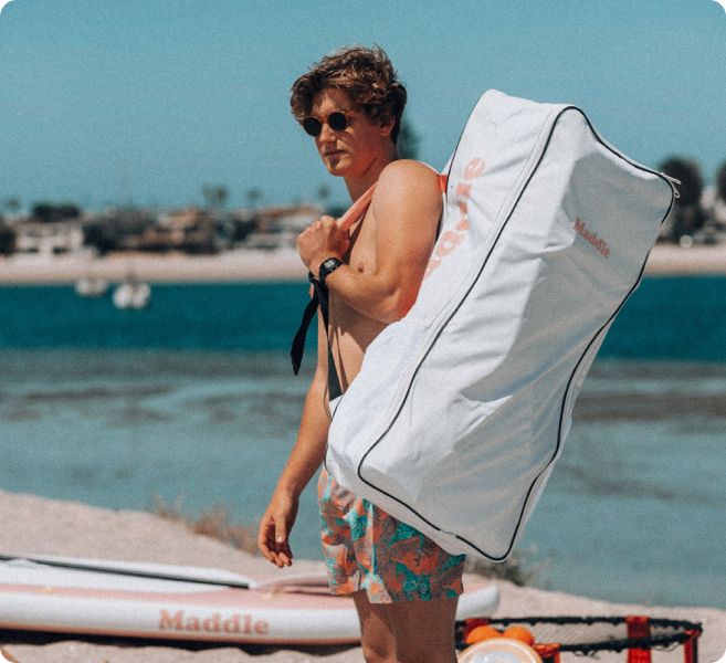 Man on beach with Maddle backpack